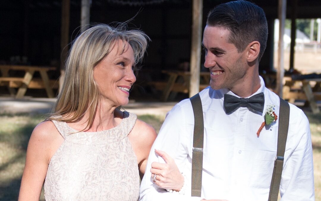 Julie, walking her son, Tyler, down the aisle at his wedding in 2016